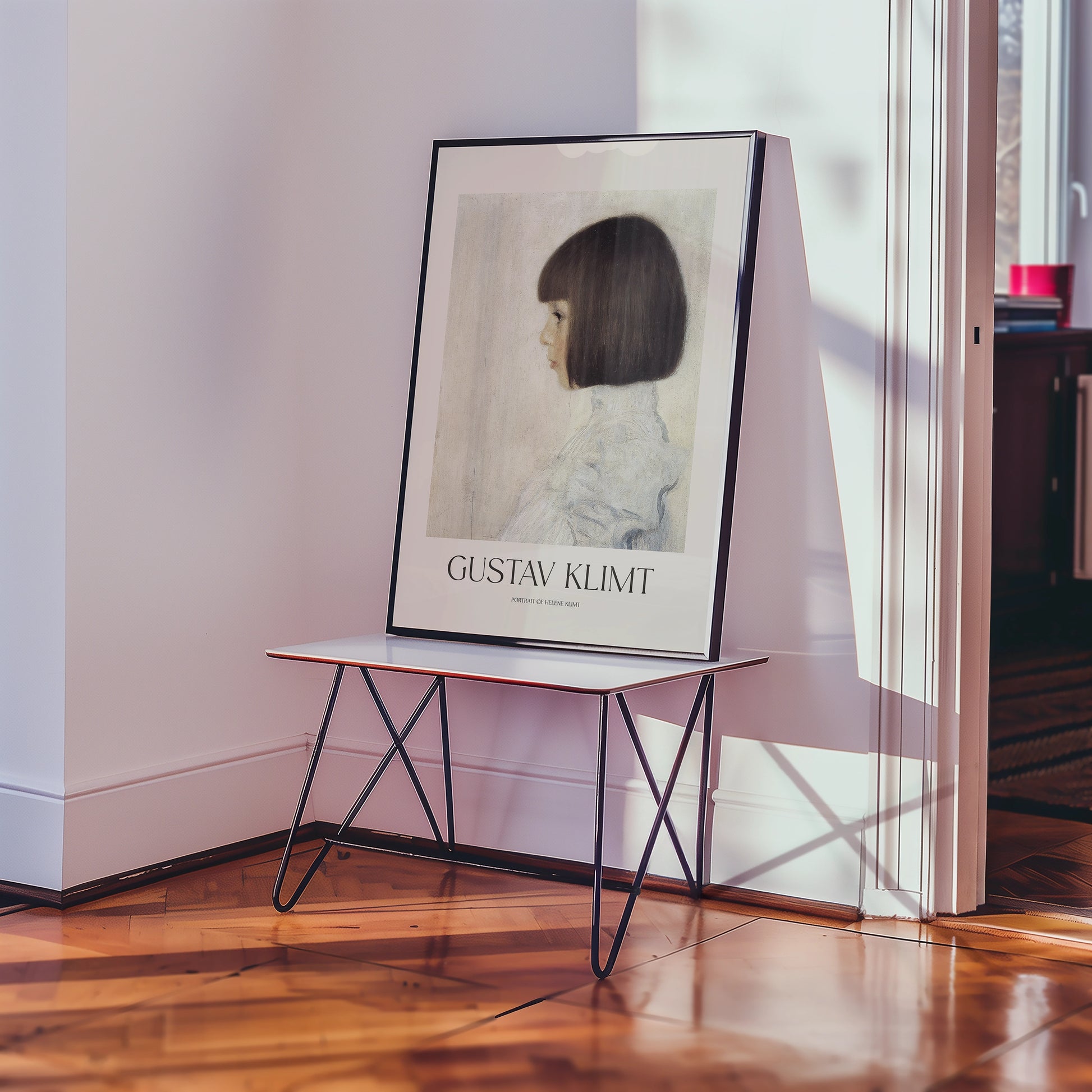 Gustav Klimt poster featuring a profile of a girl with a bob haircut, displayed on a modern table in a bright room.