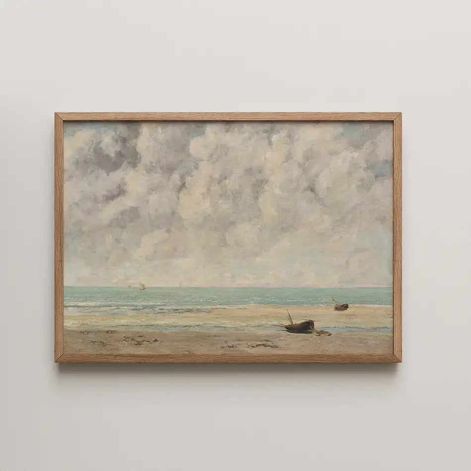 Framed painting of a serene beach scene with boats on the shore and a cloudy sky.