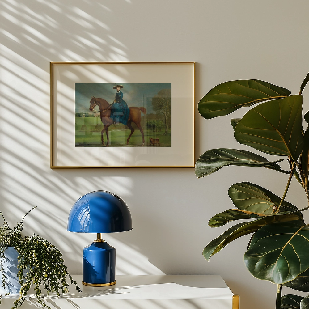 Framed painting of a woman in a blue dress riding a horse, displayed on a wall with sunlight casting shadows, accompanied by a stylish blue lamp and a green plant.