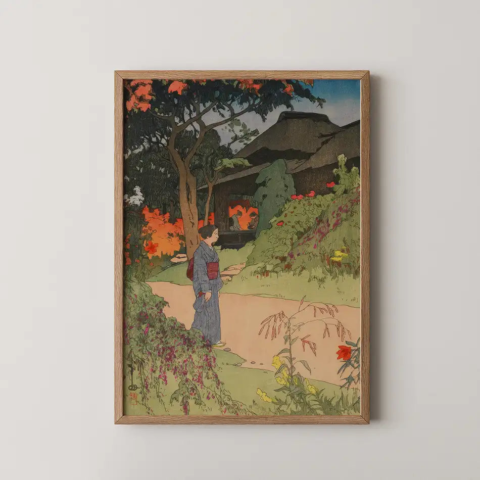 Framed painting depicting a woman in traditional clothing walking along a garden path surrounded by colorful flowers and greenery.