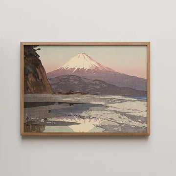 Painting of Mount Fuji at sunset, framed in wood, with a beach and calm waters in the foreground.