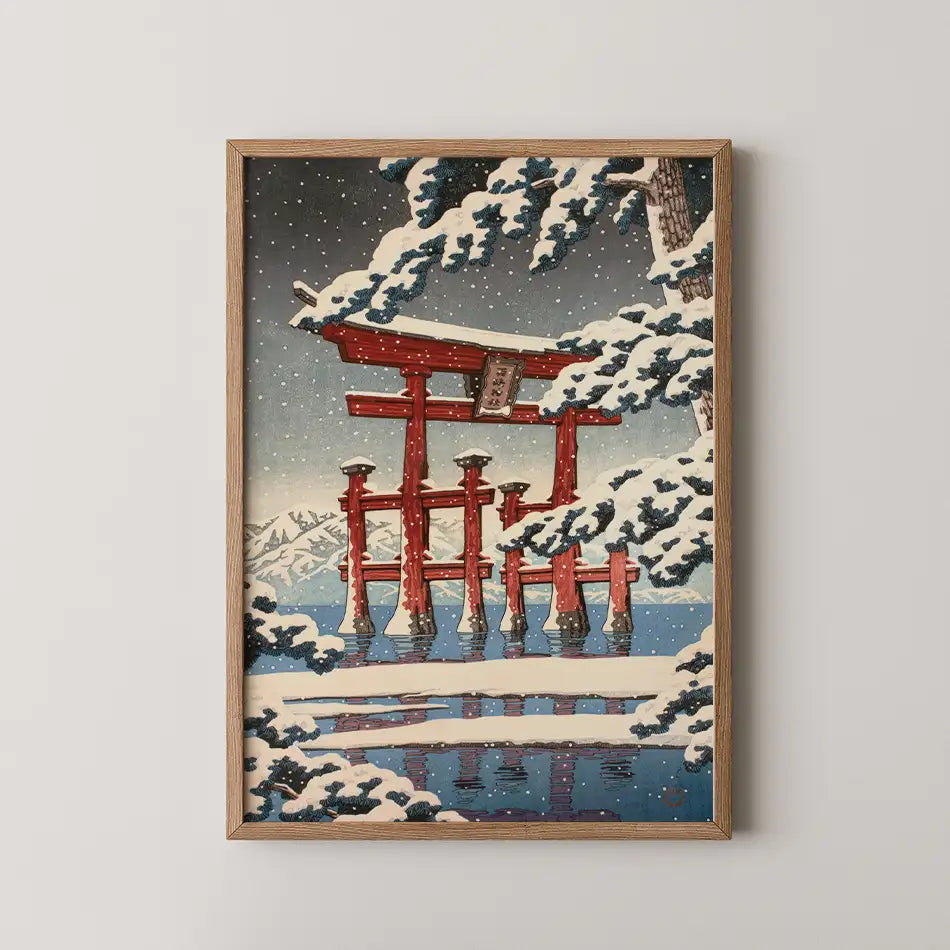 Framed painting of a red torii gate surrounded by snow-covered trees and mountains under a snowy sky.