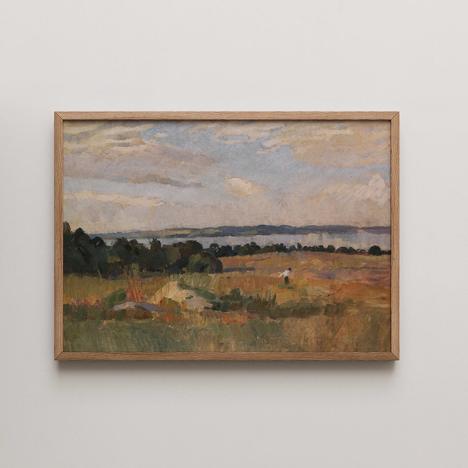 Painting of a serene landscape featuring a field, trees, and a lake under a cloudy sky, framed in natural wood.