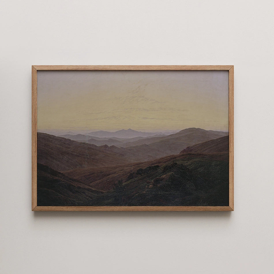 Framed landscape painting depicting rolling hills and distant mountains under a soft, muted sky.