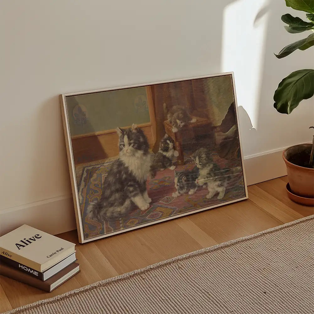 Framed painting of playful kittens on a colorful rug in a bright interior setting.