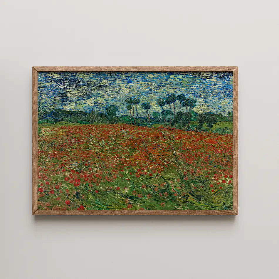 Framed painting of a vibrant field with red flowers under a blue sky and green trees in the background.