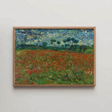 Framed painting of a vibrant field with red flowers under a blue sky and green trees in the background.