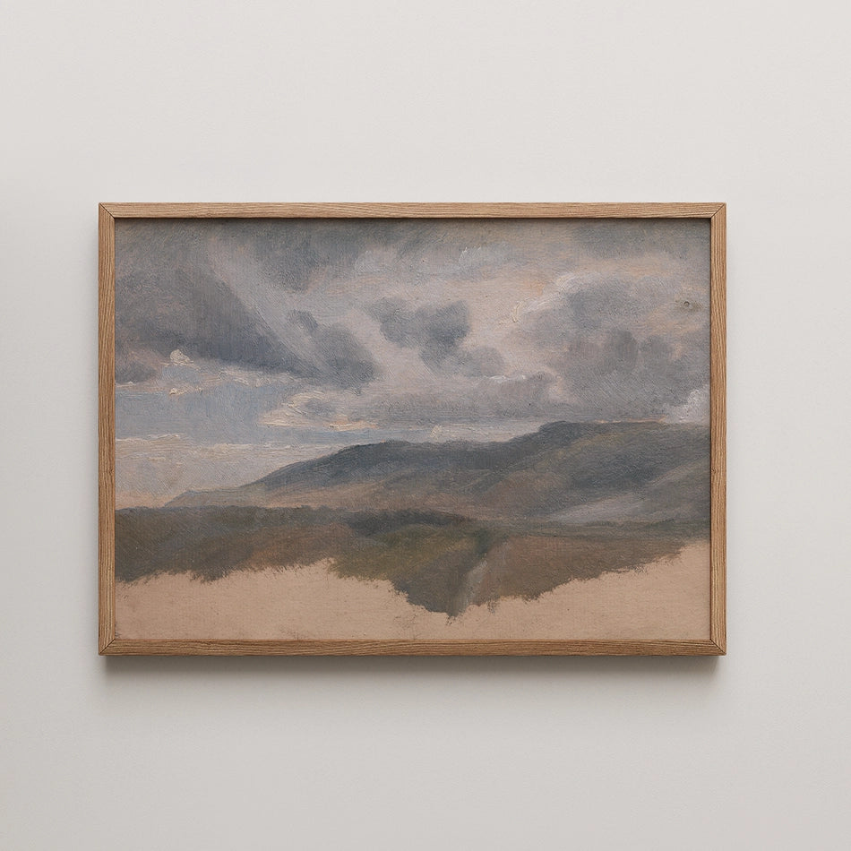 Landscape painting featuring rolling hills and a cloudy sky, housed in a wooden frame.