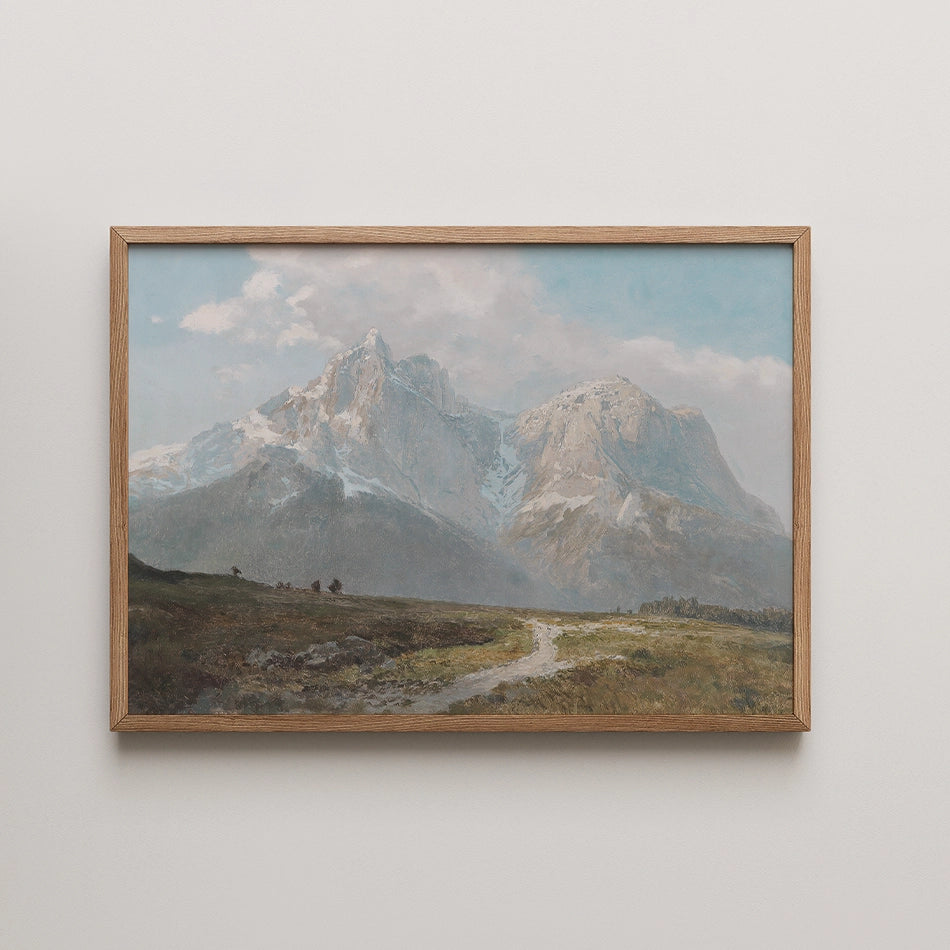 Framed painting of a scenic mountain landscape with a winding path and a blue sky.