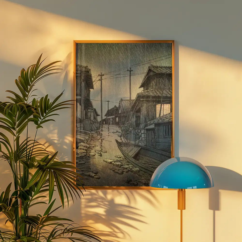 A serene vintage painting of a rain-soaked street lined with traditional houses and a small boat, displayed in a contemporary frame next to a modern lamp and greenery.