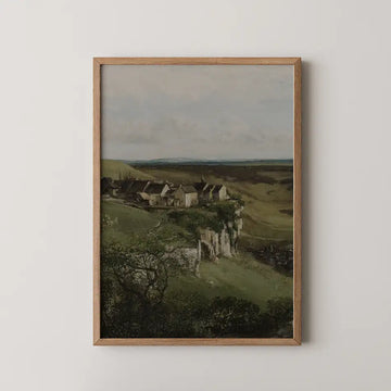 Landscape painting featuring a serene view of houses on a green hillside, framed in a Oak wood frame.