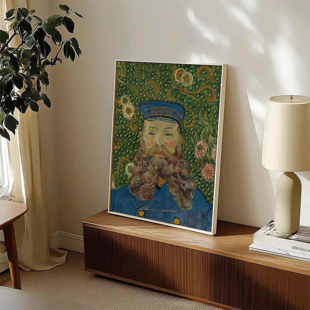 Framed painting of a bearded man in a blue uniform with a cap, set against a floral green background, displayed in a modern interior.