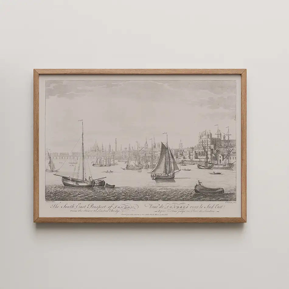 Historic black and white illustration of the southeast view of London featuring various sailing boats on the river, framed in a natural wood frame.