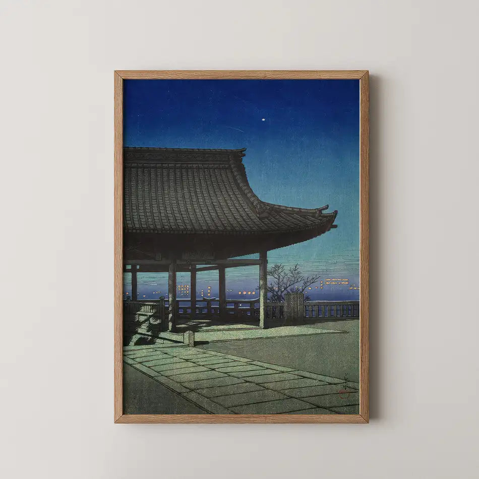 Japanese landscape painting featuring a pagoda at dusk, framed in wood.