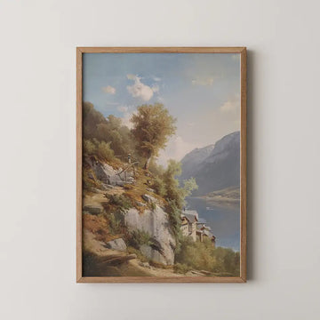 Framed landscape painting of a serene lake surrounded by mountains and trees with a small village along the shoreline