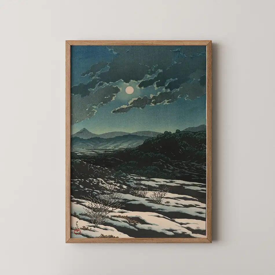 Framed painting of a moonlit landscape with clouds and mountains in the background