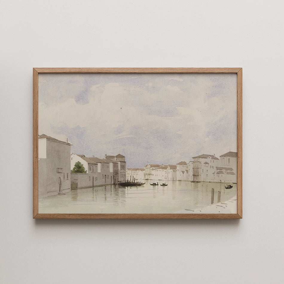 Watercolor painting of a serene canal scene with boats and buildings, framed in natural wood.