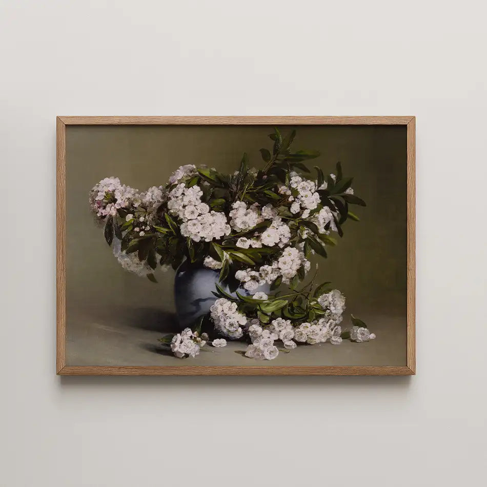 Painting of a floral arrangement featuring white flowers in a blue vase, set against a muted background, framed in natural wood.