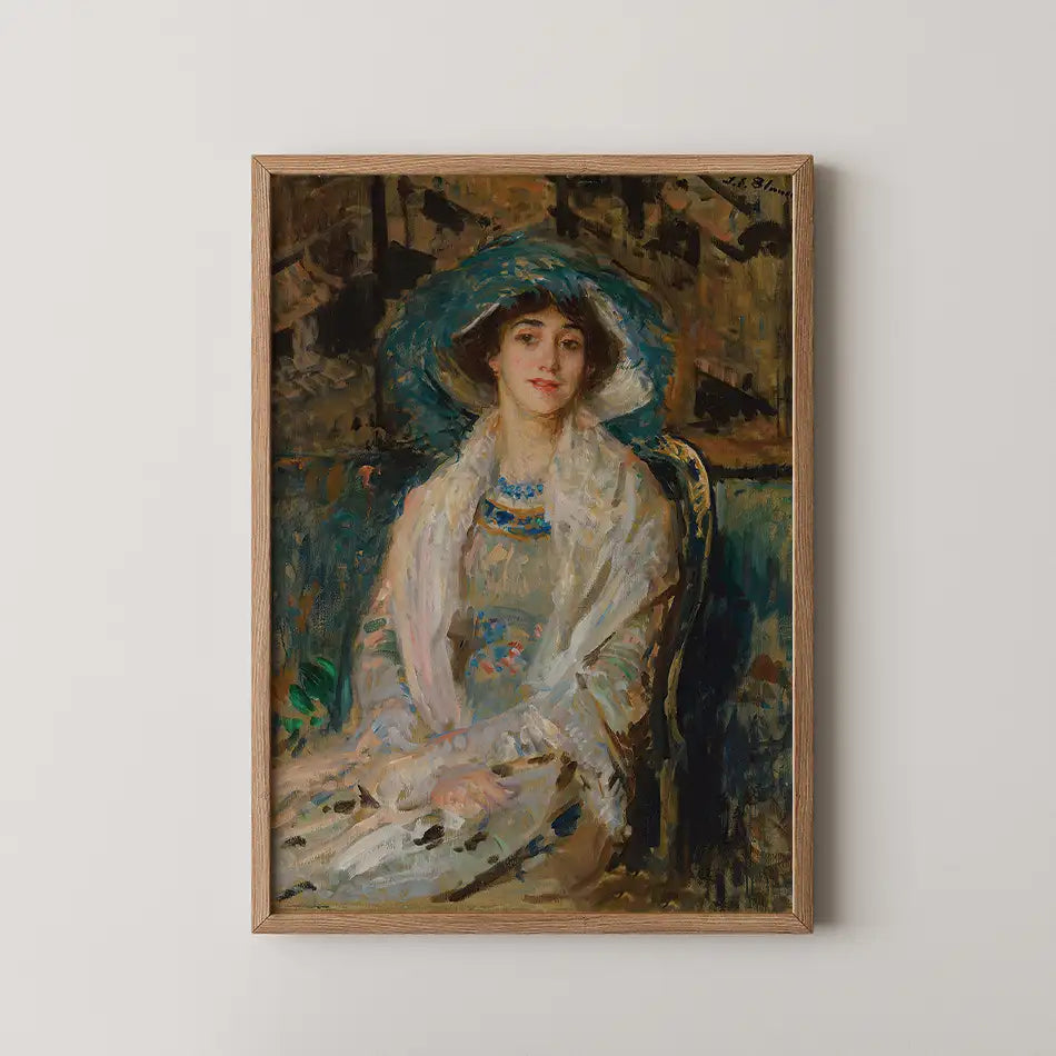 Portrait of a woman wearing a large hat and shawl, seated in an elegantly styled setting, framed in a wooden frame.