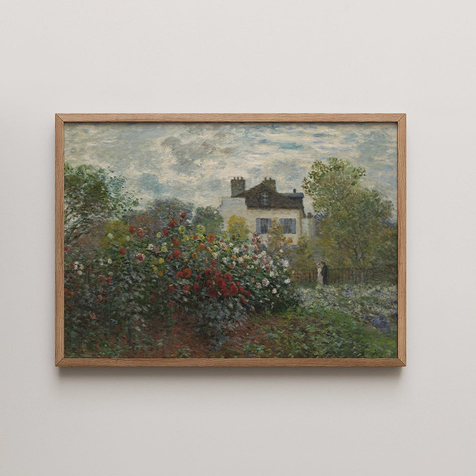 Framed painting of a house surrounded by colorful flowers and lush greenery under a cloudy sky.