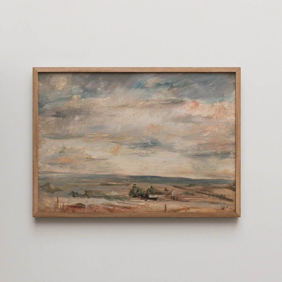 Framed landscape painting with soft clouds and muted colors in a Oak wood frame.