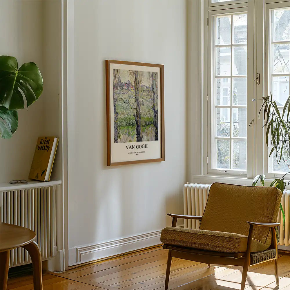 Framed Van Gogh painting on a white wall in a cozy living room setting with a chair and a plant nearby.