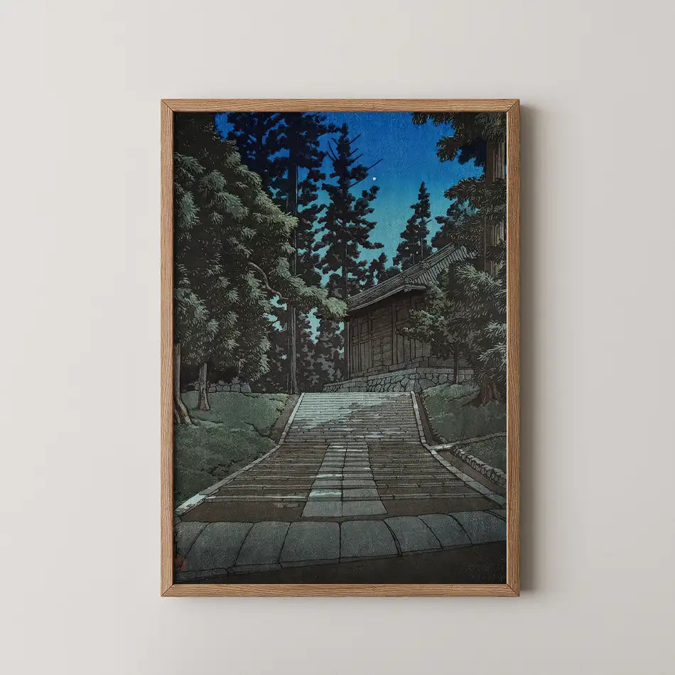 Framed painting of a serene pathway leading to a traditional building surrounded by tall trees under a twilight sky.