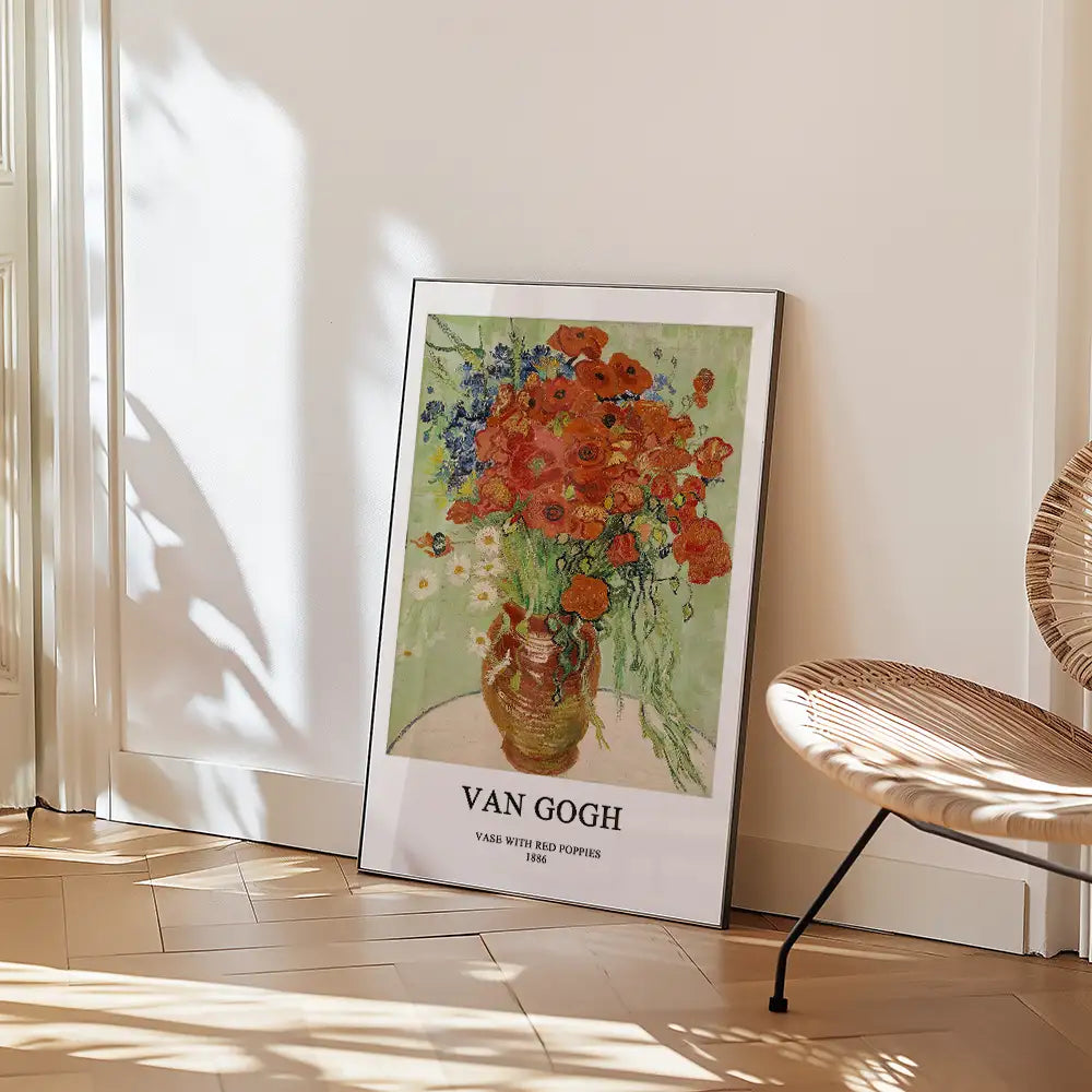 Van Gogh poster of "Vase with Red Poppies" featuring vibrant flowers in a ceramic vase, framed and leaning against a wall in an elegantly designed interior space.