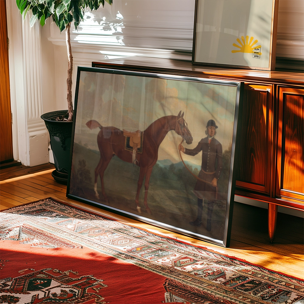 A framed painting of a man in historical clothing standing next to a brown horse, displayed on a wooden floor beside a potted plant and illuminated by soft natural light.