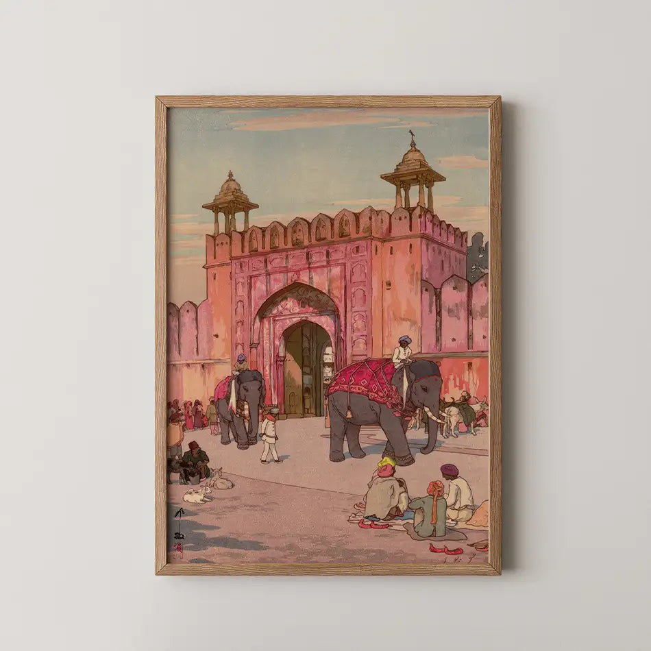 Framed painting of an ornate pink fort entrance with elephants and people interacting in a bustling market scene.