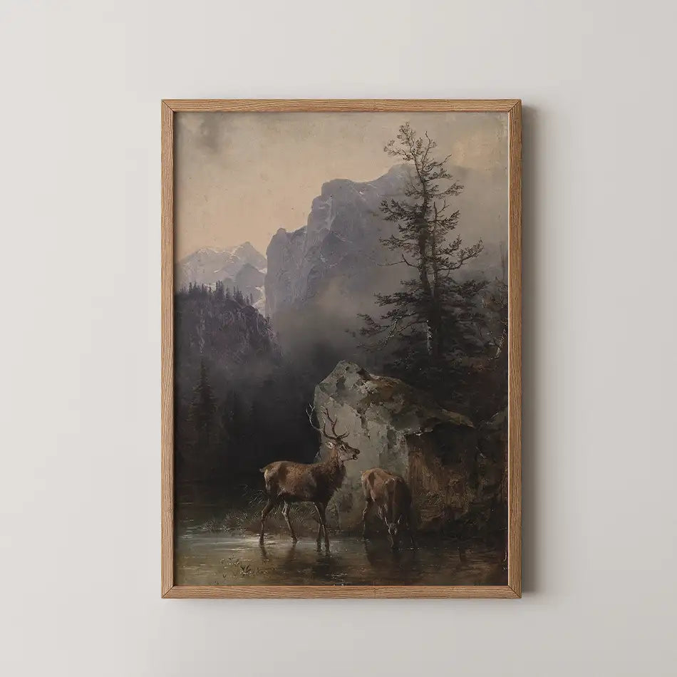Framed painting of two deer by a mountain stream in a misty landscape
