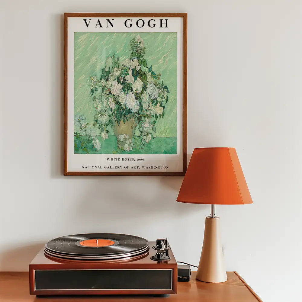 Vincent Van Gogh "White Roses" art print framed on a wall with a record player and orange lamp in a modern interior setting.