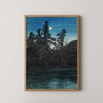 Framed painting of a serene night scene featuring silhouetted trees and a reflection on water under a starry sky.