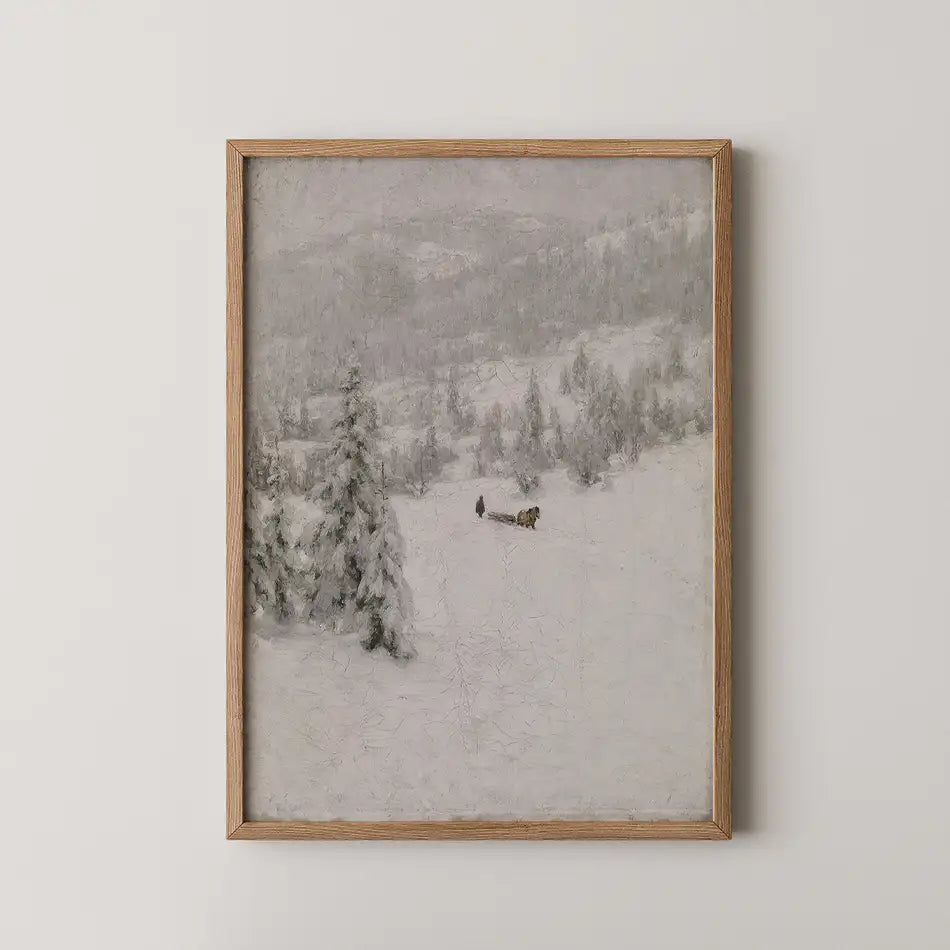 Framed painting of a snowy landscape featuring trees and a figure pulling a sled in winter scenery.