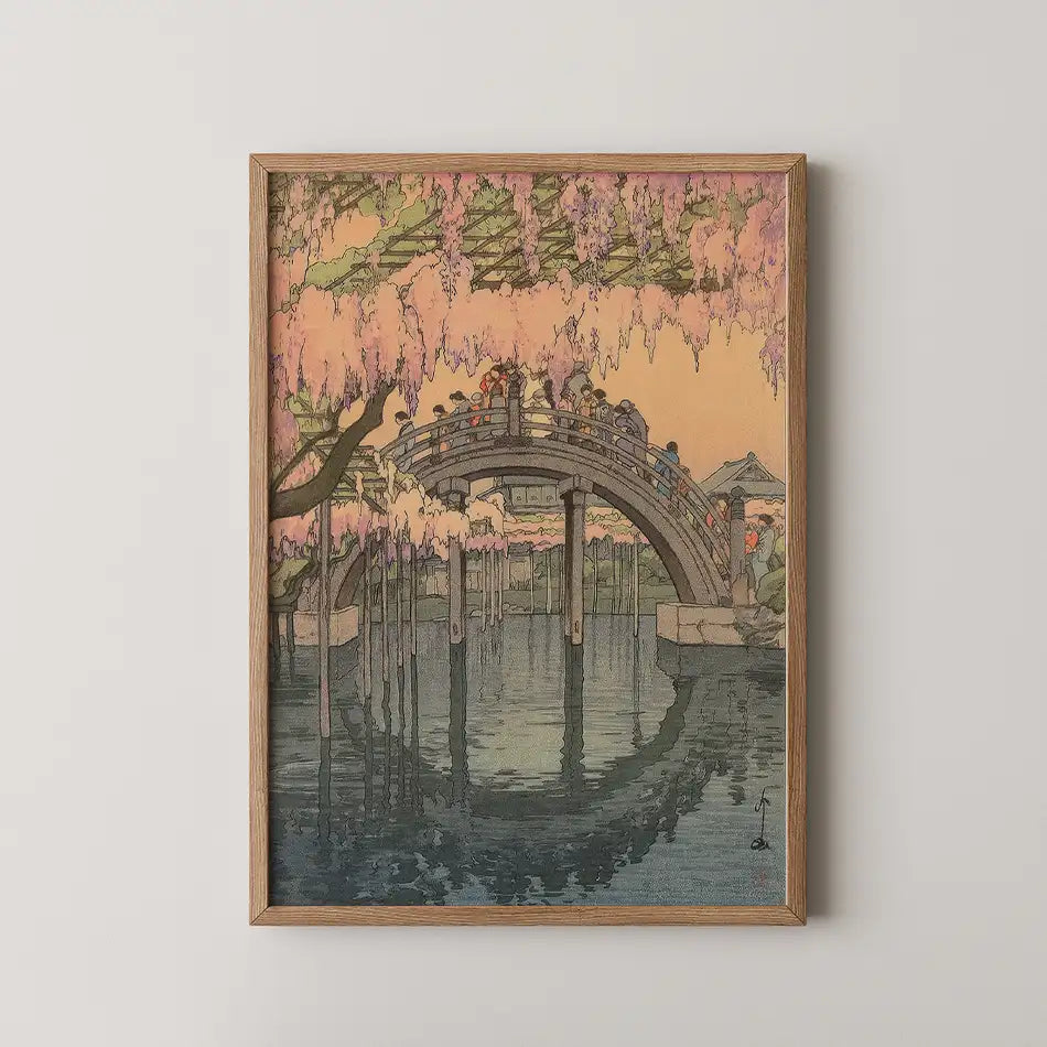 Framed painting of a tranquil scene with a bridge and cherry blossoms reflecting in water, featuring pastel colors and intricate details.
