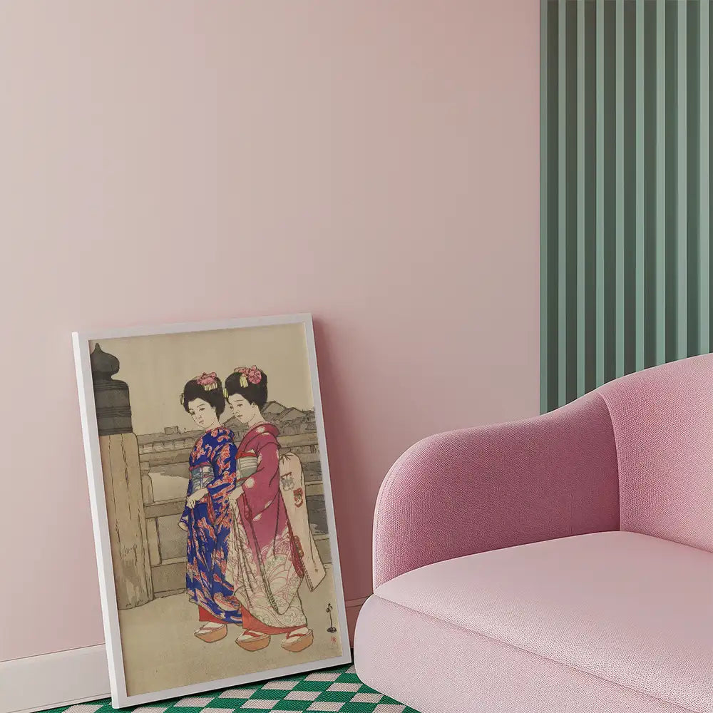Painting of two women in traditional kimonos displayed in a modern living room setting with a pink couch.