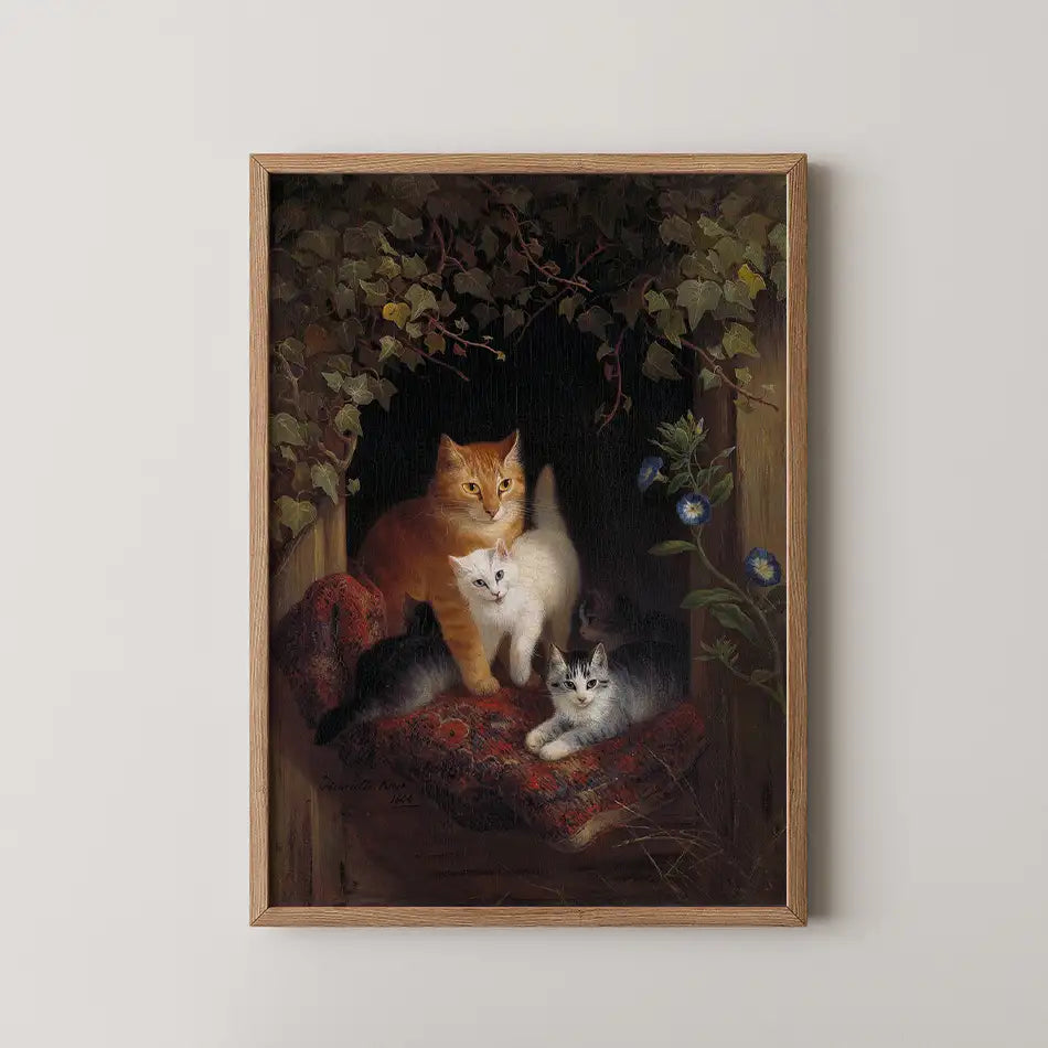 Cat painting featuring a ginger cat and two other cats resting on a patterned fabric surrounded by greenery and flowers, framed in wood.