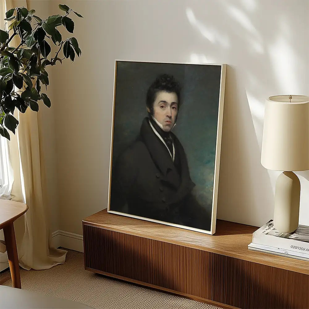 Portrait painting displayed in a modern living room setting, featuring a man in a dark coat, with soft natural lighting and a plant in the background.
