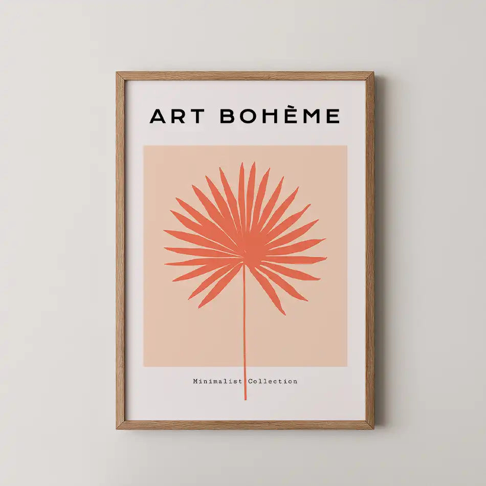 Modern minimalist art print featuring a coral palm frond on a peach background, framed in wood, part of the Abstract Collection titled 'Sun Fan'"