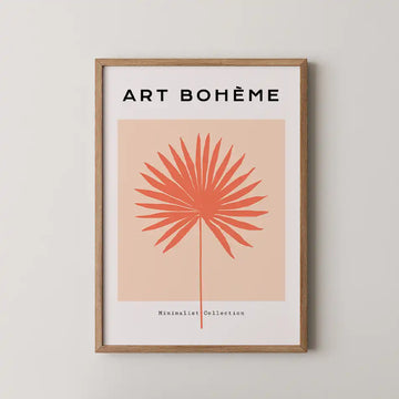 Modern minimalist art print featuring a coral palm frond on a peach background, framed in wood, part of the Abstract Collection titled 'Sun Fan'"