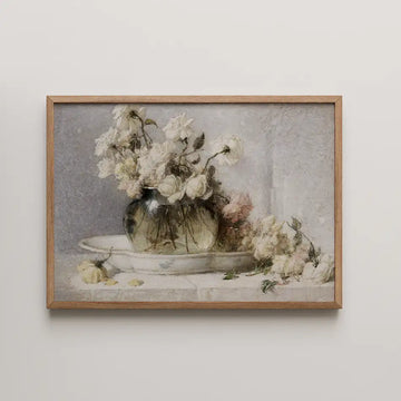 Painting of a vase filled with white roses on a plate, framed in light wood.