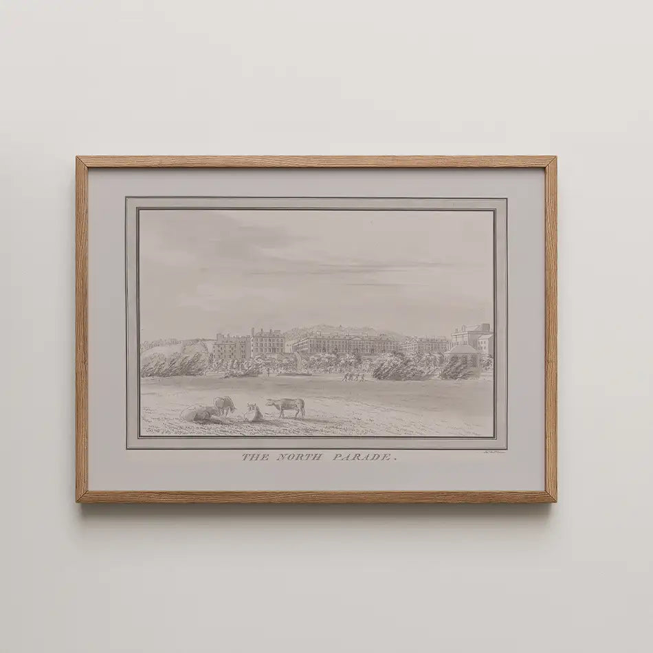 Framed monochrome illustration titled "The North Parade," depicting a coastal scene with cows and buildings in the background.