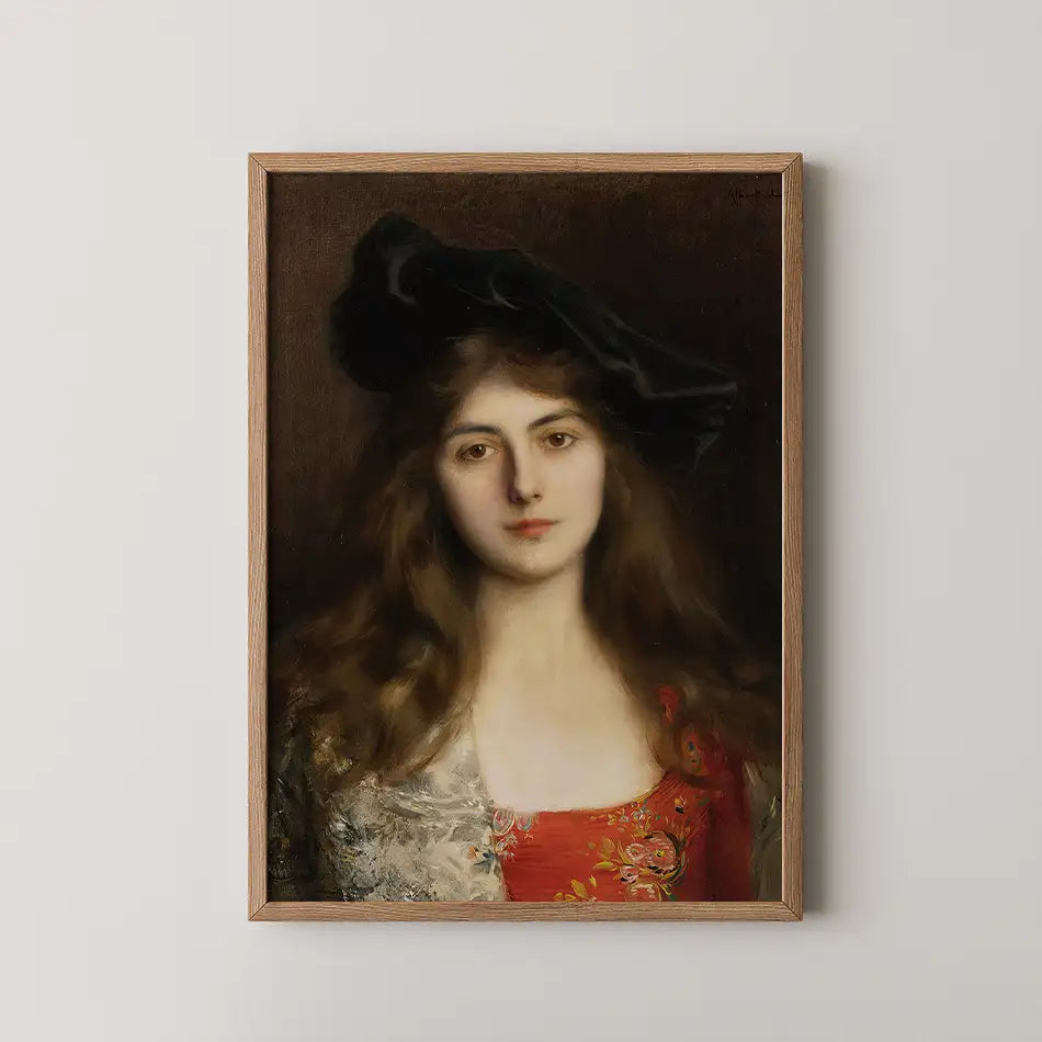 Portrait of a young woman with long hair wearing a black hat and a colorful dress, framed in wood against a neutral background.