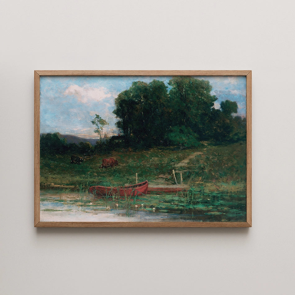 Painting of a serene landscape featuring a tranquil body of water with two red boats, surrounded by lush greenery and grazing cattle under a partly cloudy sky, framed in natural wood.