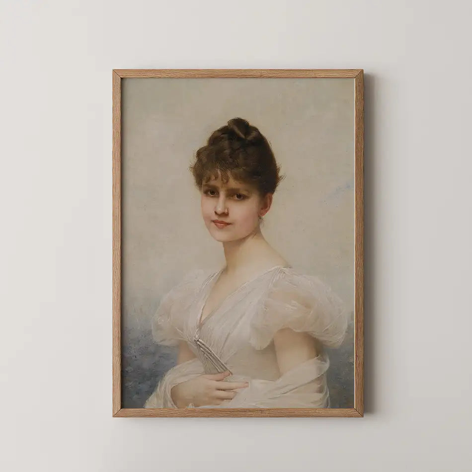 Portrait of a woman in a delicate historical dress, framed in light wood, set against a soft, muted background.