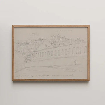 Framed sketch of a town view with buildings and a person walking, featuring light pencil work and an oak frame.