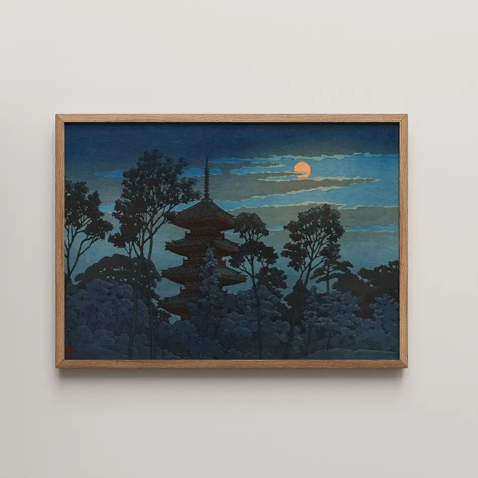 Framed painting of a pagoda surrounded by trees under a moonlit sky.