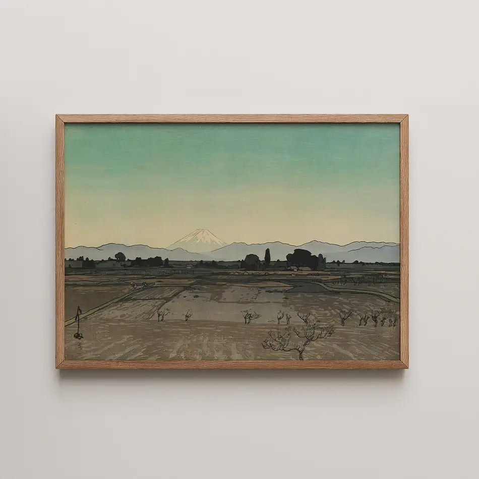 Framed painting of a serene landscape featuring mountains in the background, a gently colored sky, and fields with trees.