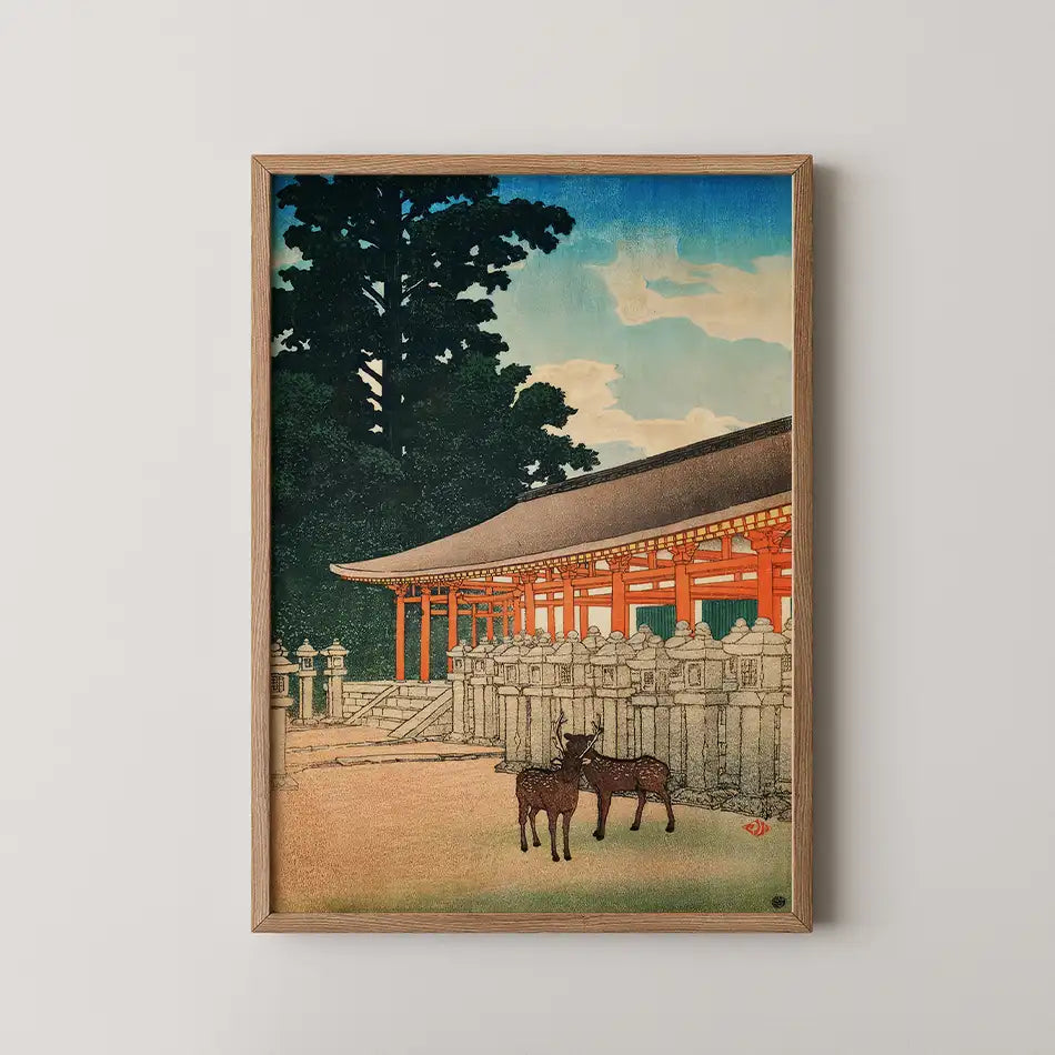 Framed painting of a traditional Japanese temple with two deer in the foreground, featuring vibrant colors and a serene sky.
