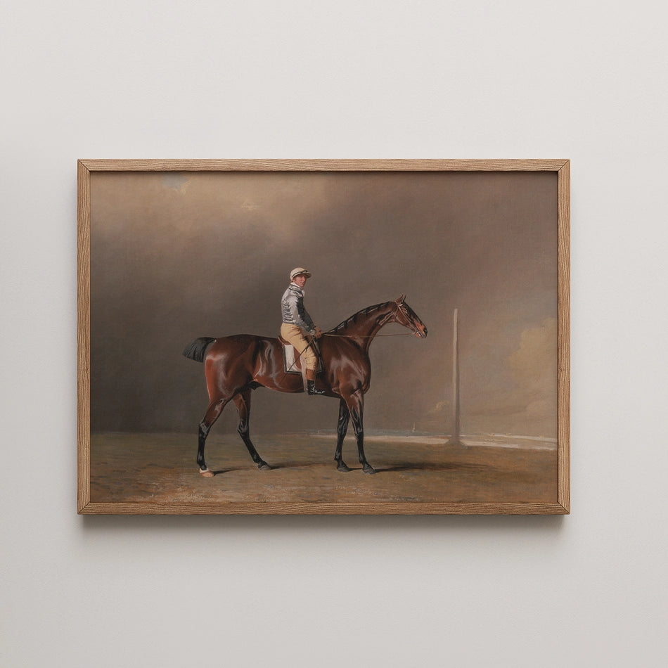 Portrait of a horse and rider in a framed painting, showcasing a brown horse standing on a dirt track with a blurred background.